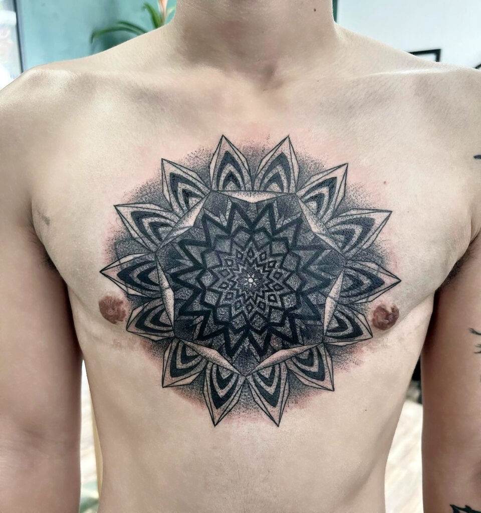 A person with a large, intricate geometric star tattoo centered on their chest.