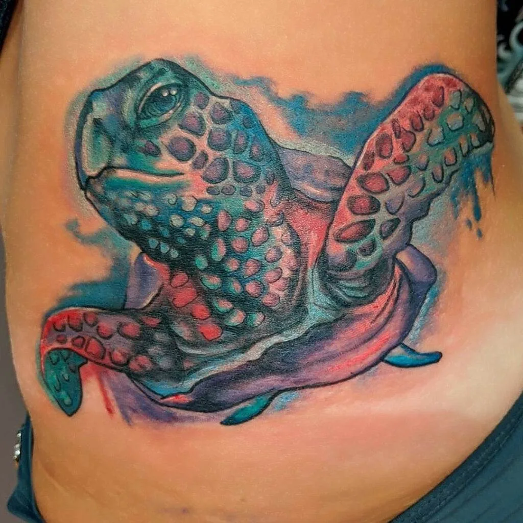 Tattoo of a colorful sea turtle on a person's side torso, showcasing detailed texture and shading.